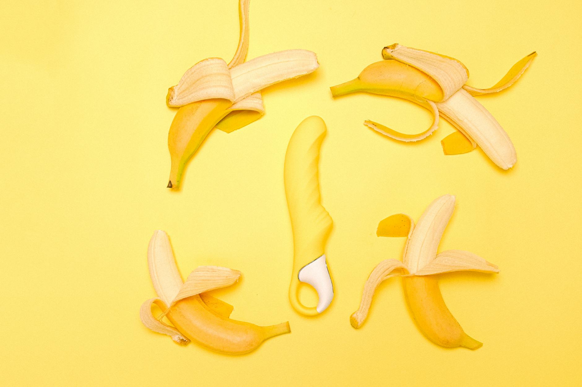 Yellow lemon-shaped vibrator on a bright yellow background symbolizing warmth and reconnection