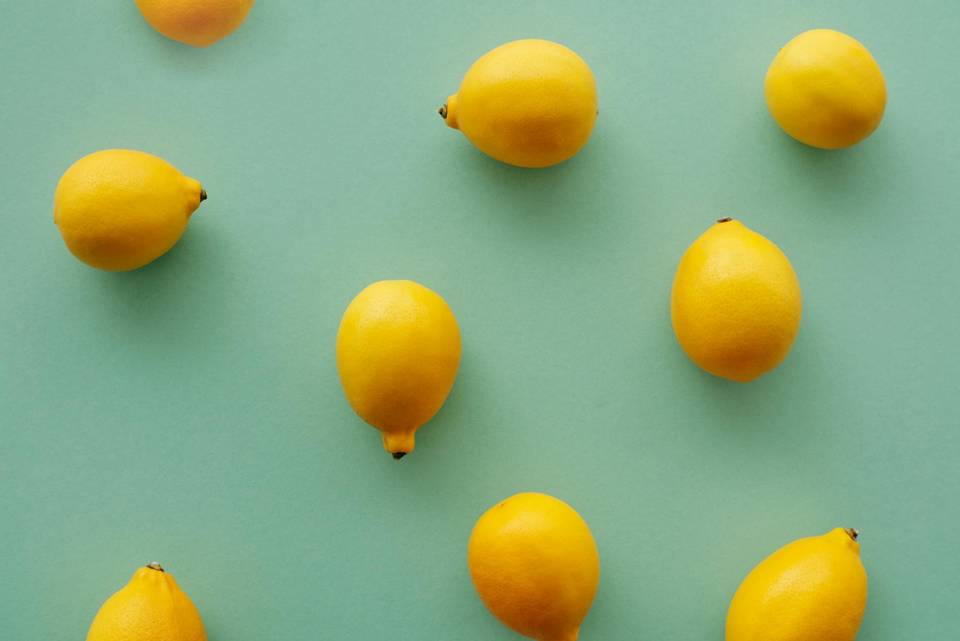Bright yellow lemons arranged on a pastel background, symbolizing openness and fresh approaches to intimate communication